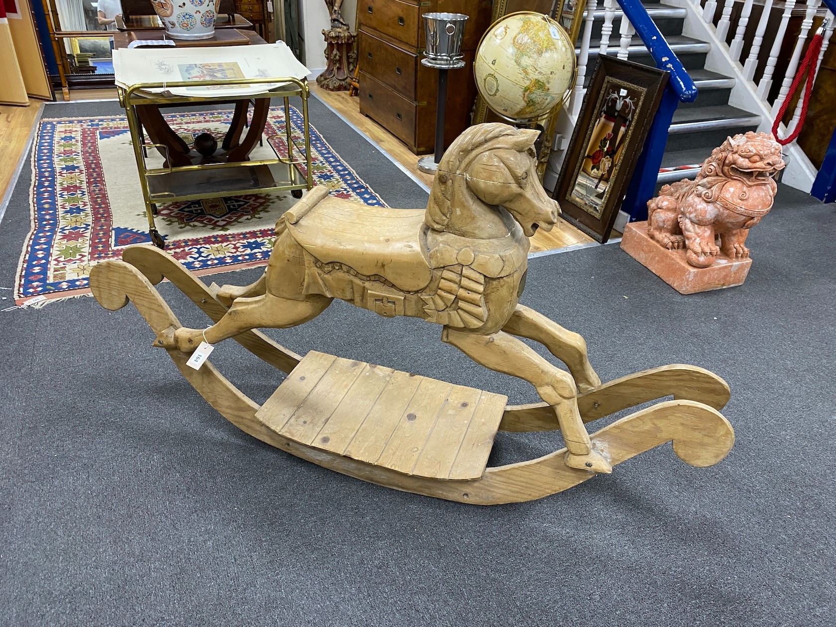 A carved pine rocking horse, height 93cm.